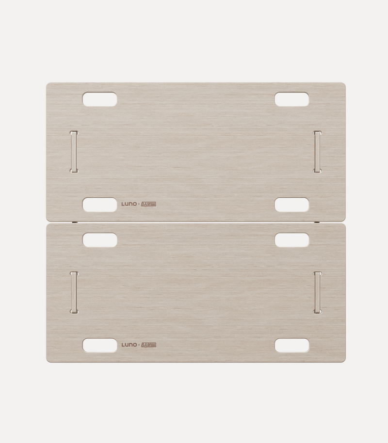 Two rectangular wooden boards with rounded corners, each featuring four cutout handles and several narrow slots. The boards are placed together, one above the other, with the brand name "Luno" printed on the lower left corner of each board.