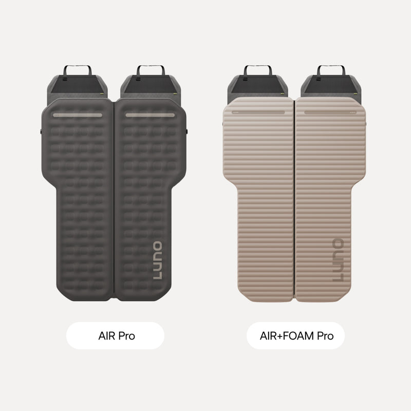 Two Subaru Crosstrek Car Camping Mattresses on a light surface: the left is dark gray with a textured finish, the right is light beige and ribbed. Both offer adventure-ready comfort for car camping.
