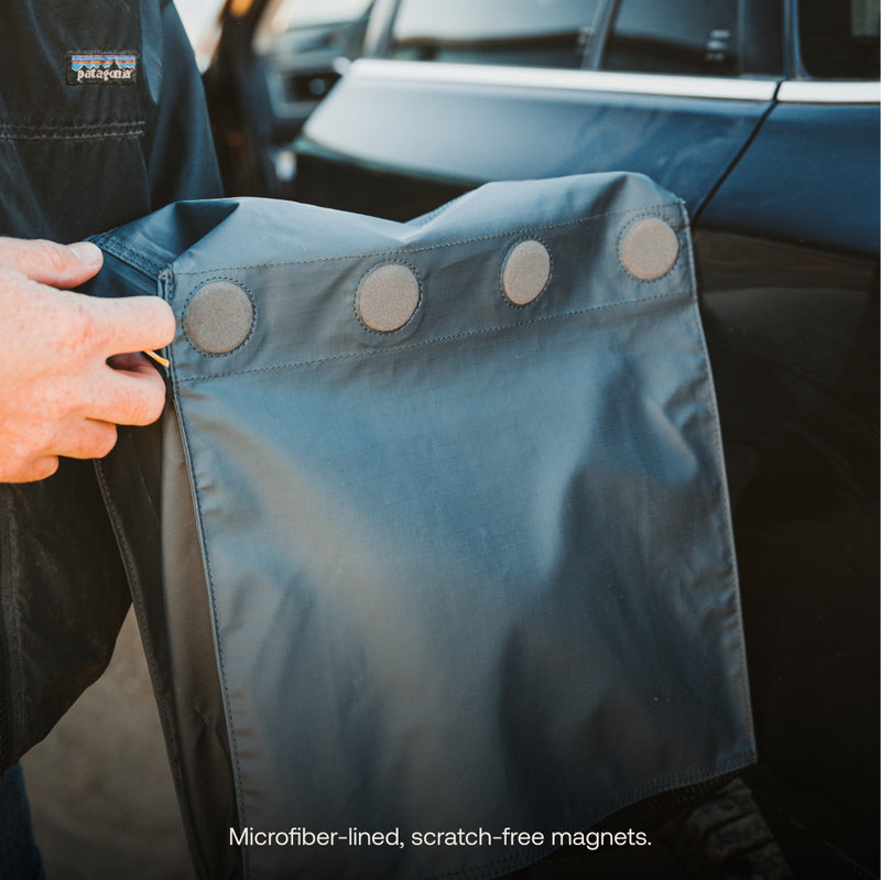 A person holds the Luno® Gear & Shoe Storage Bag—microfiber-lined, water-resistant, with four scratch-free magnets—next to a car door. Text at the bottom: "Microfiber-lined, scratch-free magnets.