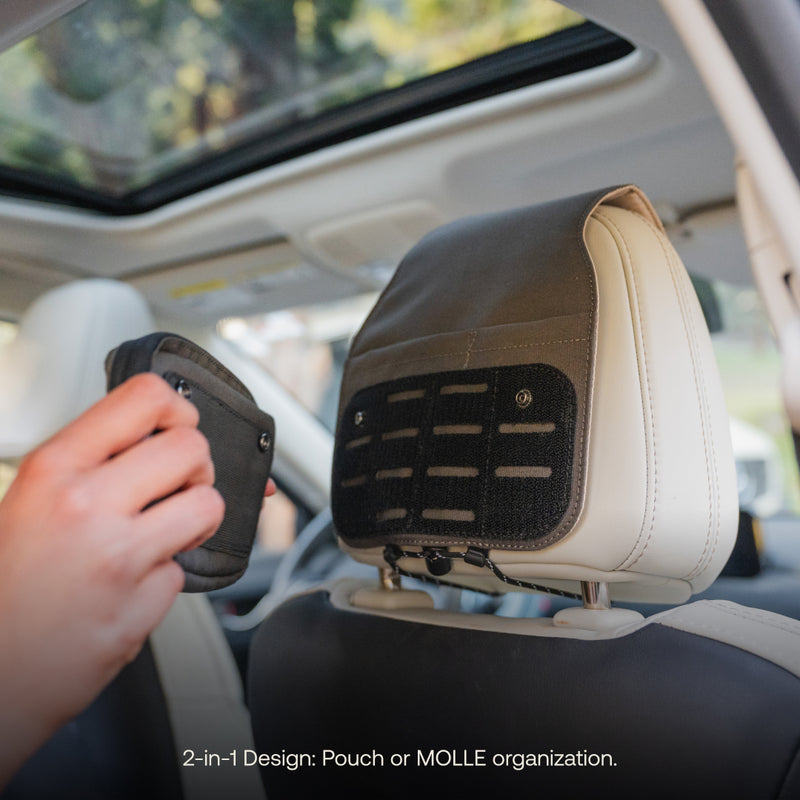 A person installs a pre-owned Luno HQ Headrest Organizer onto a car headrest using the simple MOLLE system. The car's interior, complete with a sunroof, can be seen. Text at the bottom states, "2-in-1 Design: Headrest Organizer or MOLLE organization for practical organization.