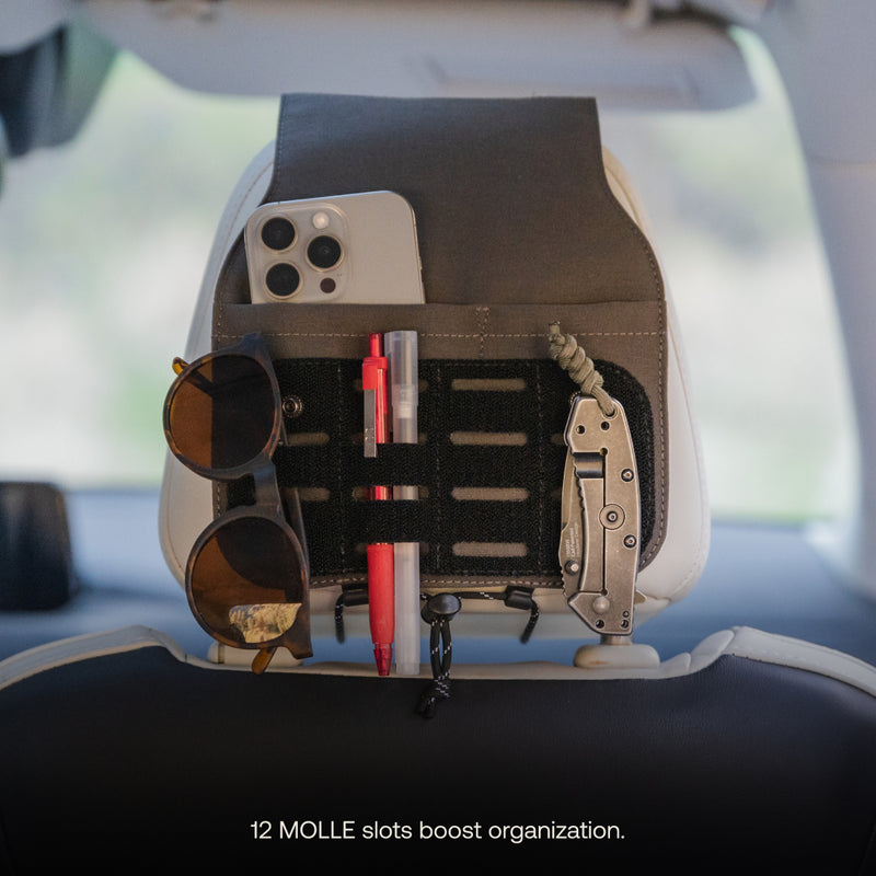 The Luno HQ Headrest Organizer (Pre-Owned), featuring 12 easy-to-install MOLLE slots, provides practical organization by securely holding items like a phone, sunglasses, pens, and a folding knife. The image highlights its versatility and convenience for every journey.