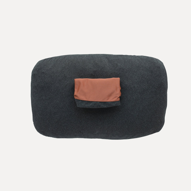 The Luno® Camping Pillowcase, a rectangular gray cover made from moisture-wicking jersey knit fabric, is showcased against a plain white background and includes a small orange pocket on top.