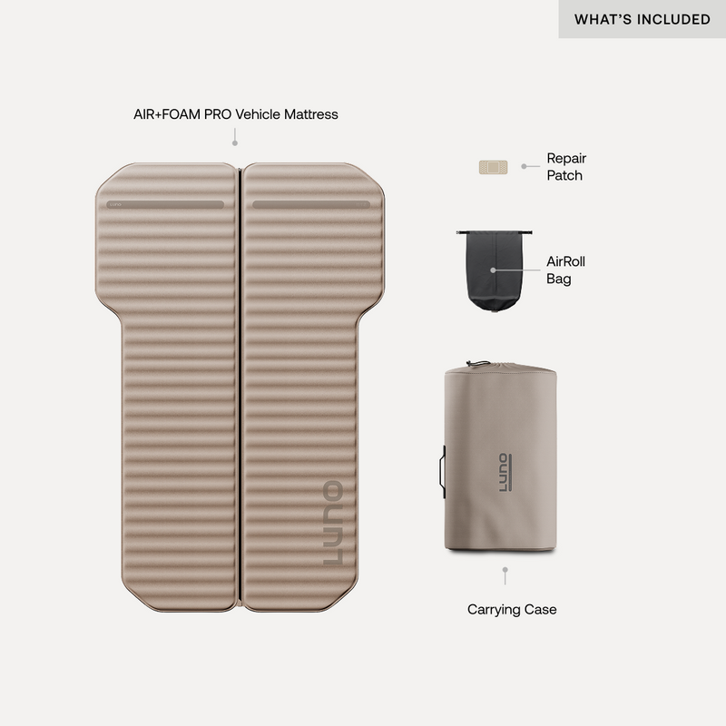 A tan Luno® AIR+FOAM PRO Rivian R1S Mattress is shown with labeled items: a repair patch, black AirRoll bag, and tan carrying case. "WHAT'S INCLUDED" appears in the top right—a complete car air mattress setup.