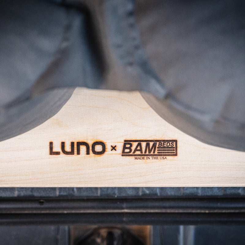 A close-up of the Vehicle Sleeping Platform shows engraved Luno x BAM Beds Made in the USA logos, partially covered by dark fabric.