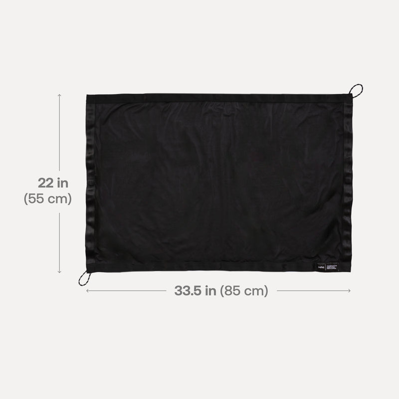 The rectangular black mesh pouch, ideal for securing your Luno® Sunroof Window Screen, measures 22 inches (55 cm) high by 33.5 inches (85 cm) wide. It has loops at each corner and scratch-free magnets for easy, damage-free attachment.