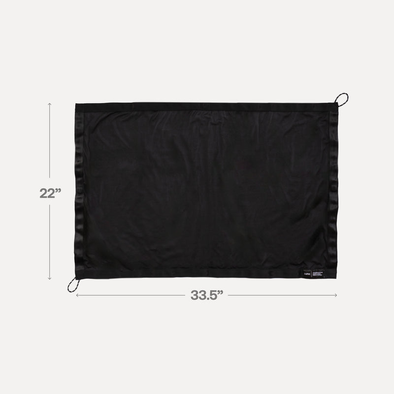 A pre-owned Luno HQ Sunroof Window Screen, in black, featuring a rectangular fabric measuring 22 inches by 33.5 inches, is showcased against a plain background and designed to block insects. The loops on the top and bottom corners make it ideal for use.