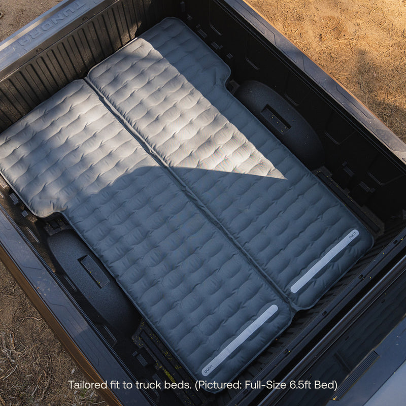 Two gray Luno® AIR Truck Bed Mattresses are side by side in a black pickup, creating a comfy sleeping space that fits the full-size 6.5-ft bed perfectly.