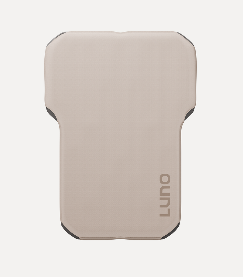 A beige, rectangular mat with slightly curved corners and the brand name "Luno" printed in gray on one side. The mat appears to be padded and designed for comfort or cushioning.