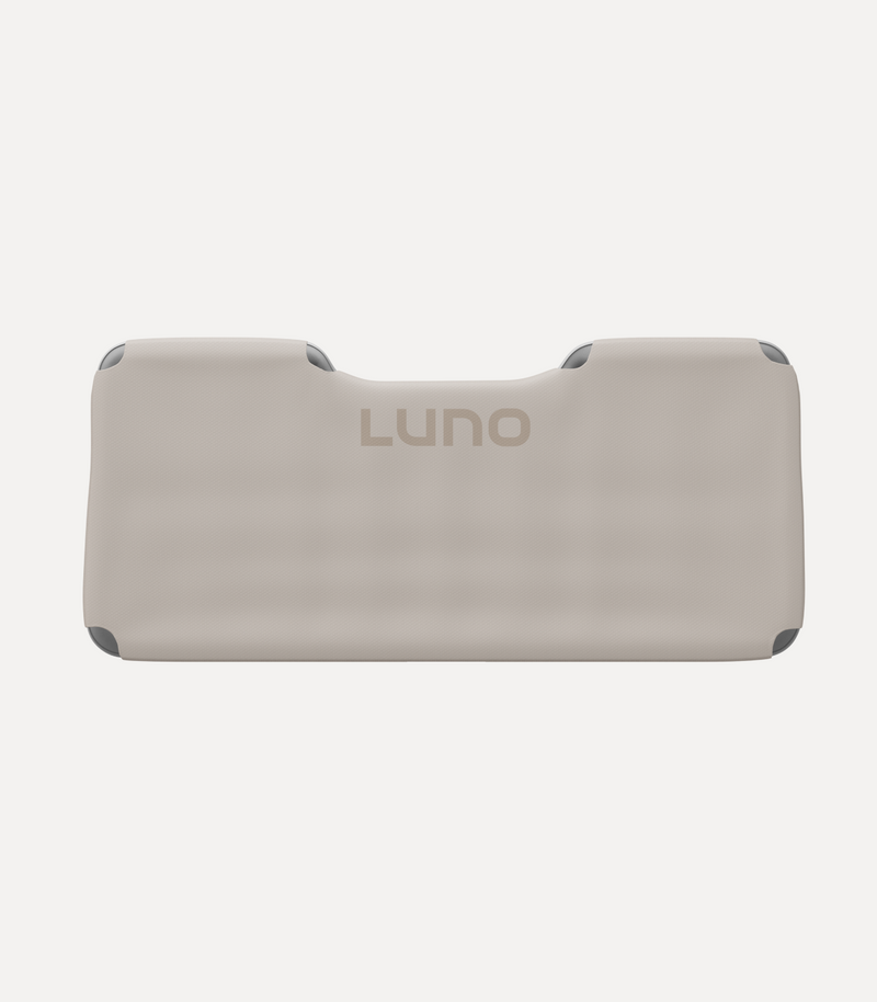 An inflatable, rectangular beige sleeping pad with slightly raised edges and a carved groove at the top center. The word "Luno" is printed in the middle in gray.