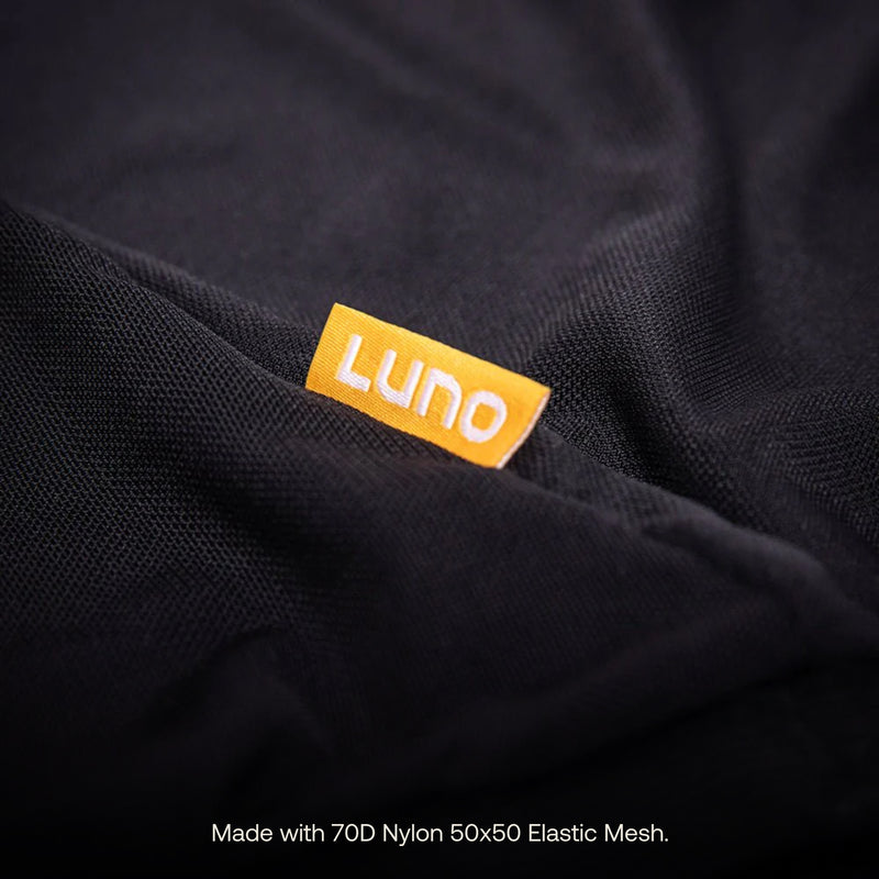 Close-up of a black fabric with an orange tag labeled "Luno." The fabric is described as made with "70D Nylon 50x50 Elastic Mesh" in white text at the bottom of the image, perfect for Luno® Car Window Screens to ensure airflow while blocking insects.