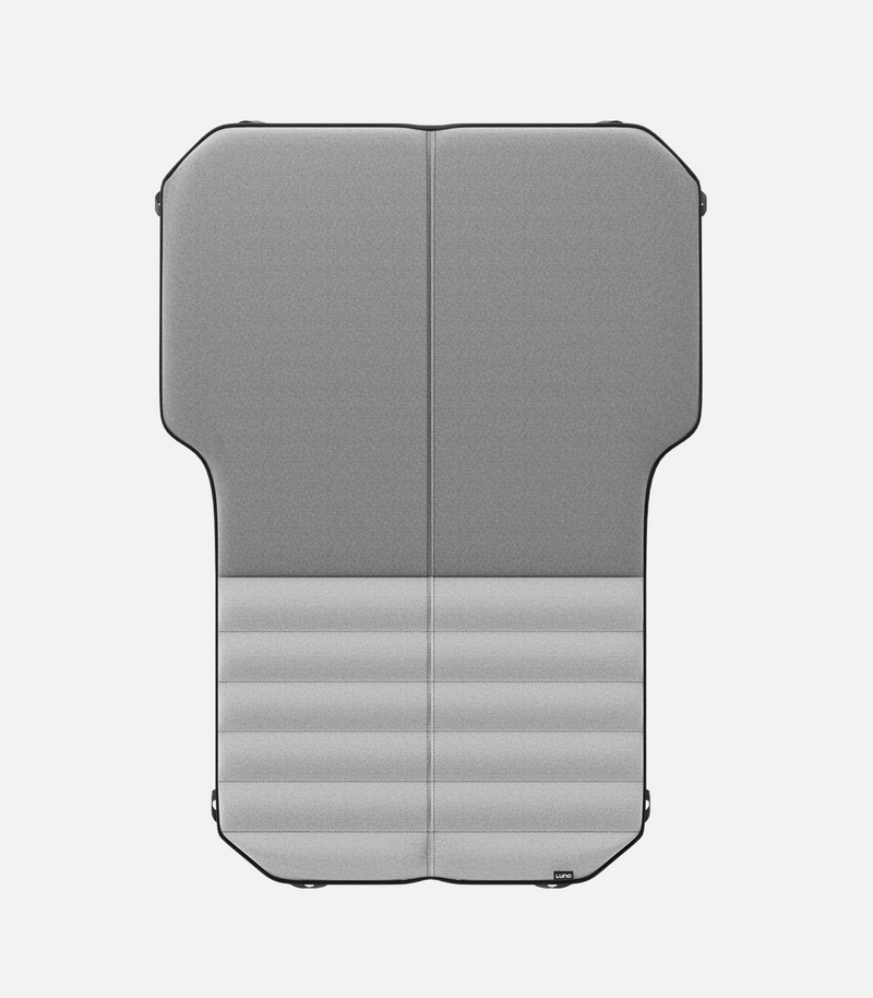 A gray, foldable, cushioned car seat protector with a vertical split in the middle, designed to cover the backseat area. The bottom half has horizontal stitched lines for added grip and comfort. The protector is shown on a white background.