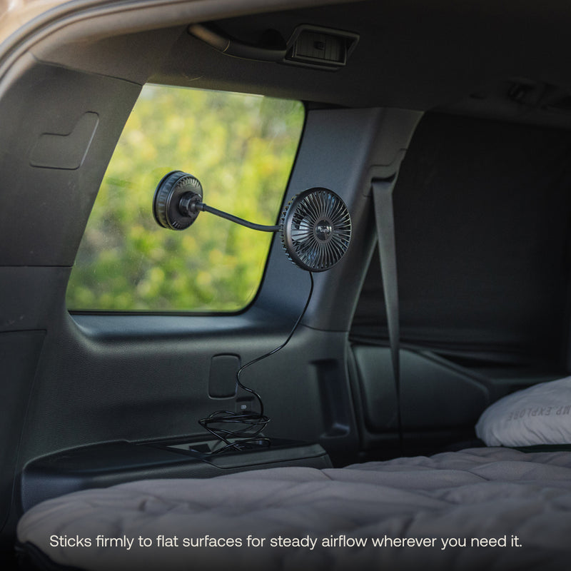 The Luno® Camping Fan is a compact black USB-C fan with a flexible neck that suctions to your vehicle’s window, directing airflow over your backseat mattress—perfect for car camping. Sticks firmly to flat surfaces for steady airflow wherever you need it.