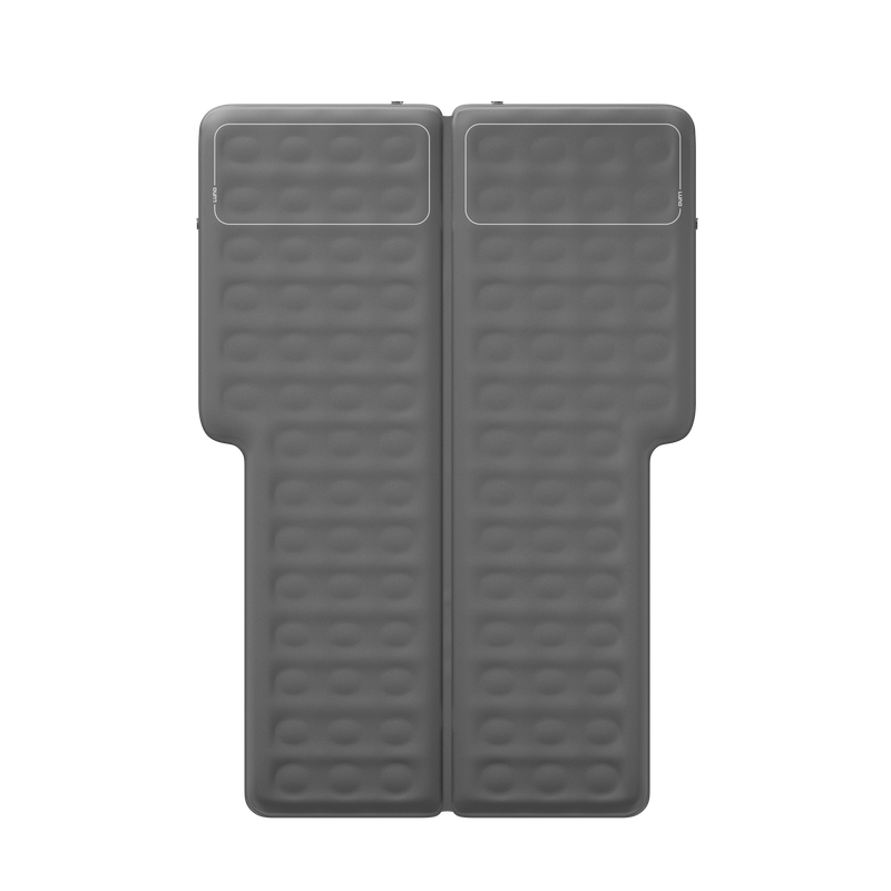 A top-down view of a rectangular, grey, inflatable mattress with a T-shape design. The mattress has a section for head support and a parallel layout of multiple small circular indentations. The material appears to be smooth and durable.